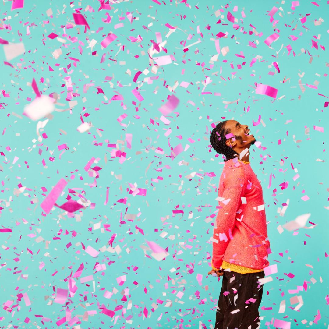 Student standing in confetti